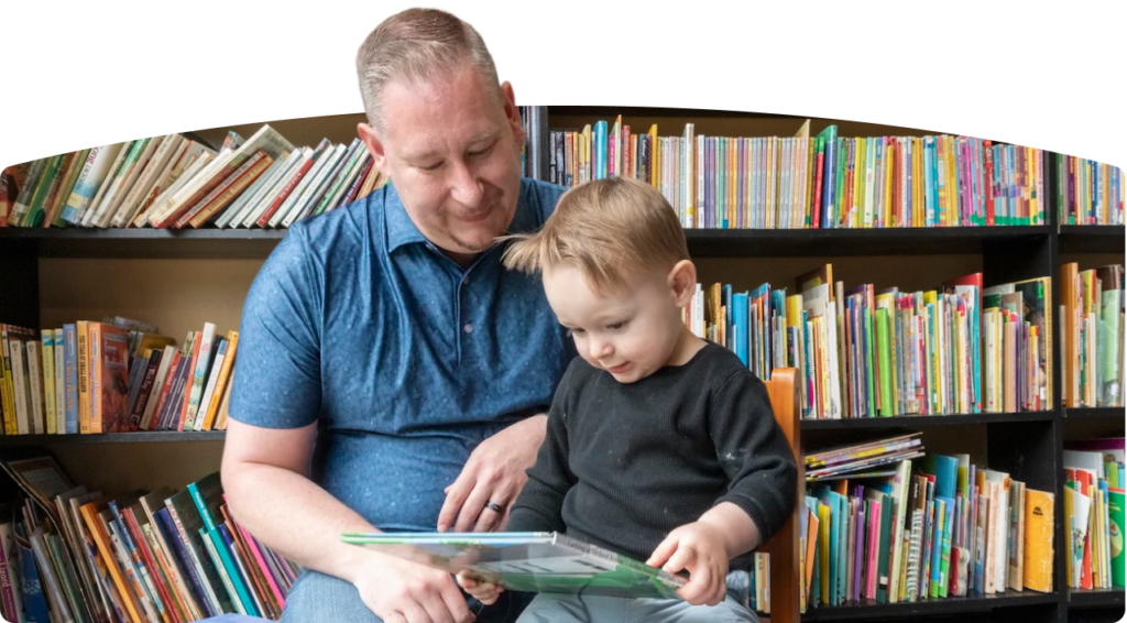 Man and boy reading in a library